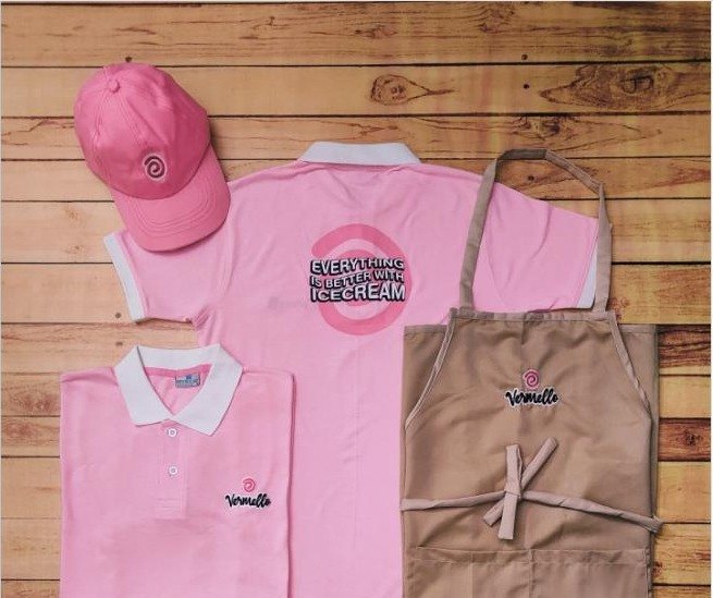 Ice cream parlour uniforms, pink polo t-shirts, pink cap and khaki aprons with playful branding