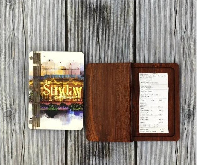 Handcrafted dark MDF bill holders with printed artwork panel, made for daily cafe use