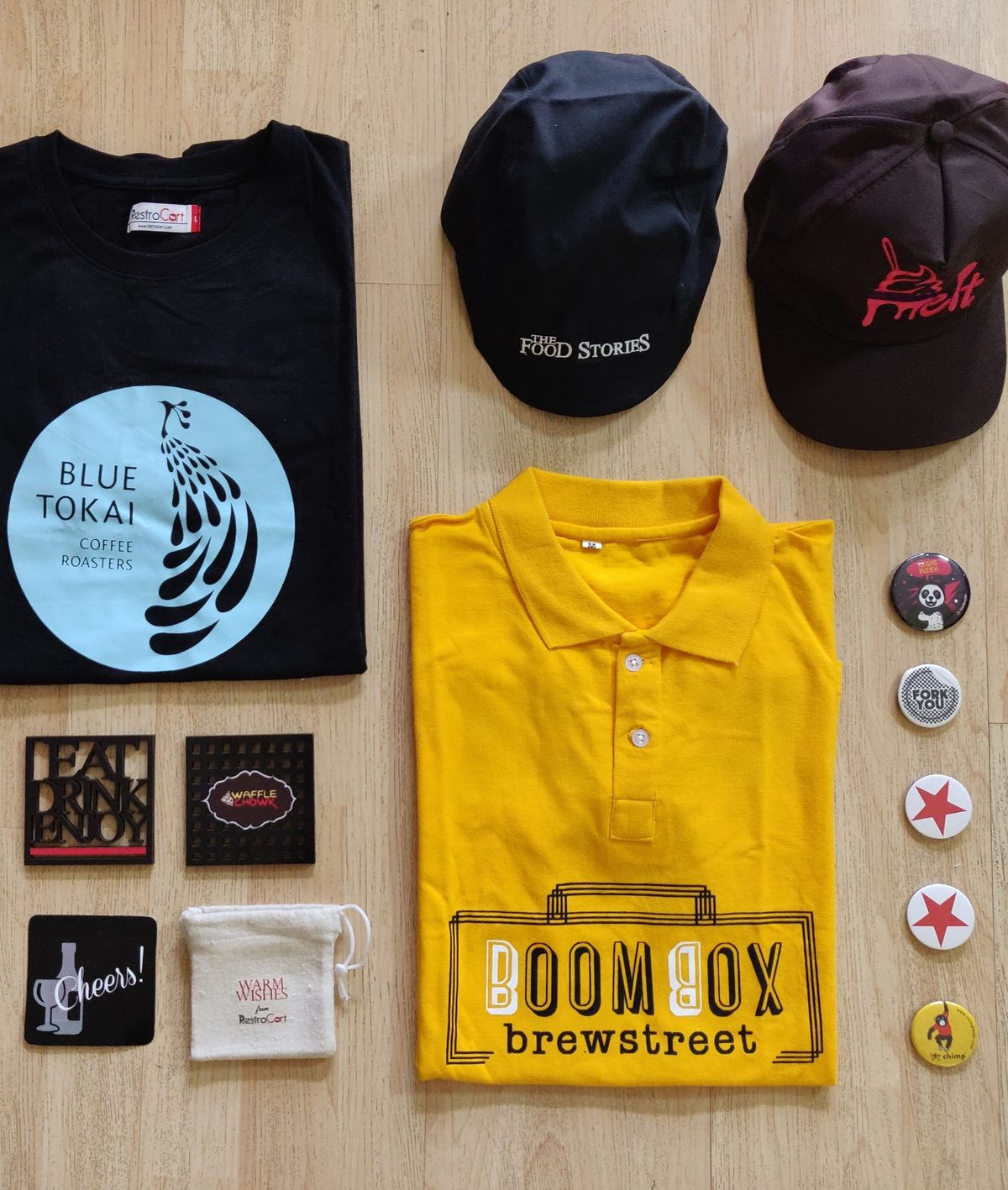 Restaurant merchandise set with t-shirts, caps and button badges made for Boombox Brewstreet